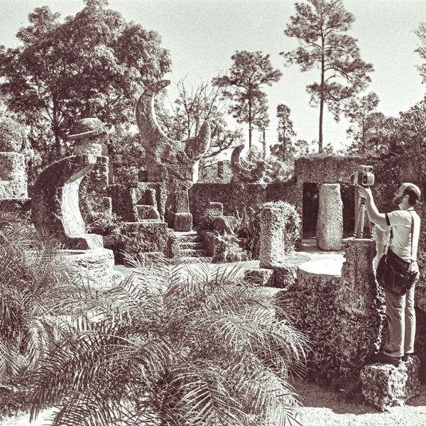 Man photograping in a coral castle or lunar landsacpe